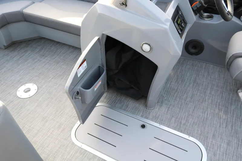 Slide: The Image of 2021 Bennington L22 boat interior with open storage compartment and gray flooring. - 39