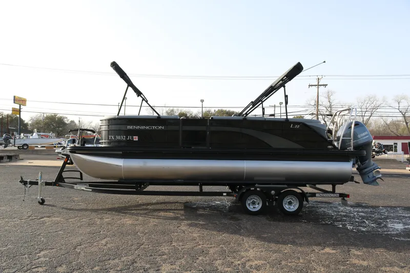 Slide: The Image of 2021 Bennington L22 pontoon boat on trailer, parked outdoors. - 4