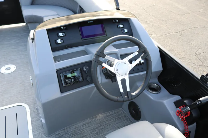 Slide: The Image of 2021 Bennington L22 boat dashboard with steering wheel and control panel. - 40