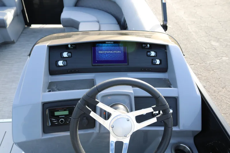 Slide: The Image of 2021 Bennington L22 boat dashboard with steering wheel and control panel. - 41