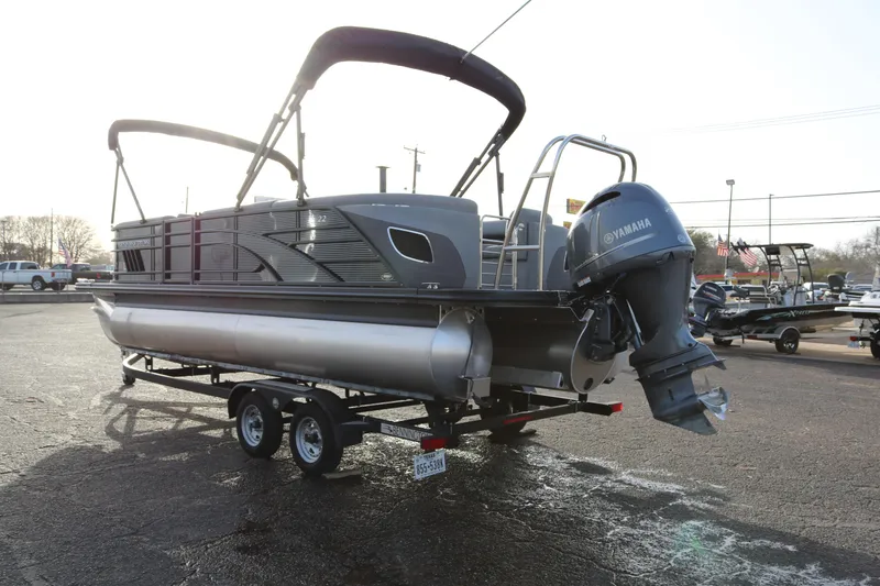 Slide: The Image of 2021 Bennington L22 pontoon boat with Yamaha outboard engine on trailer. - 5