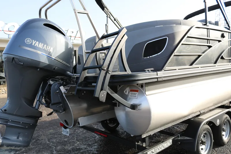 Slide: The Image of 2021 Bennington L22 pontoon boat with Yamaha outboard motor on trailer. - 8
