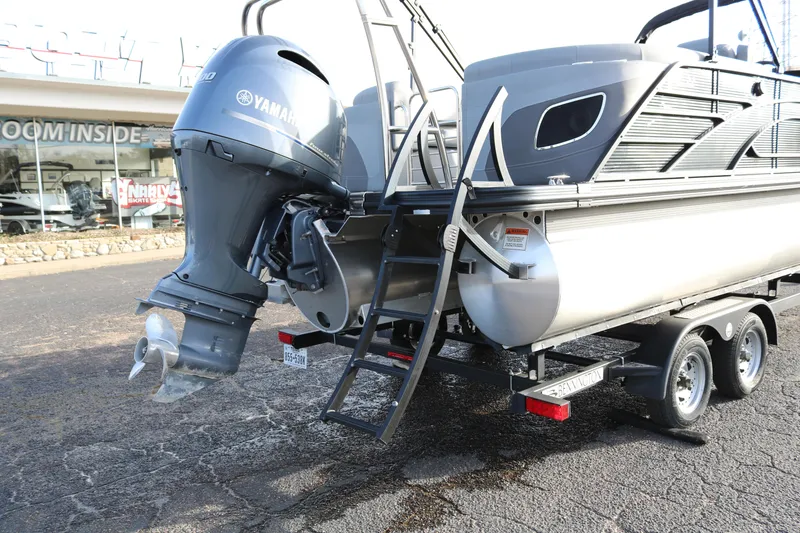 Slide: The Image of 2021 Bennington L22 pontoon boat with Yamaha outboard motor on trailer. - 9