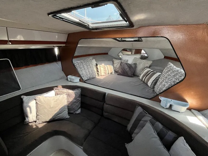 Slide: The Image of Interior of 1988 Carver 2767 Santego yacht with plush seating and decorative pillows. - 10