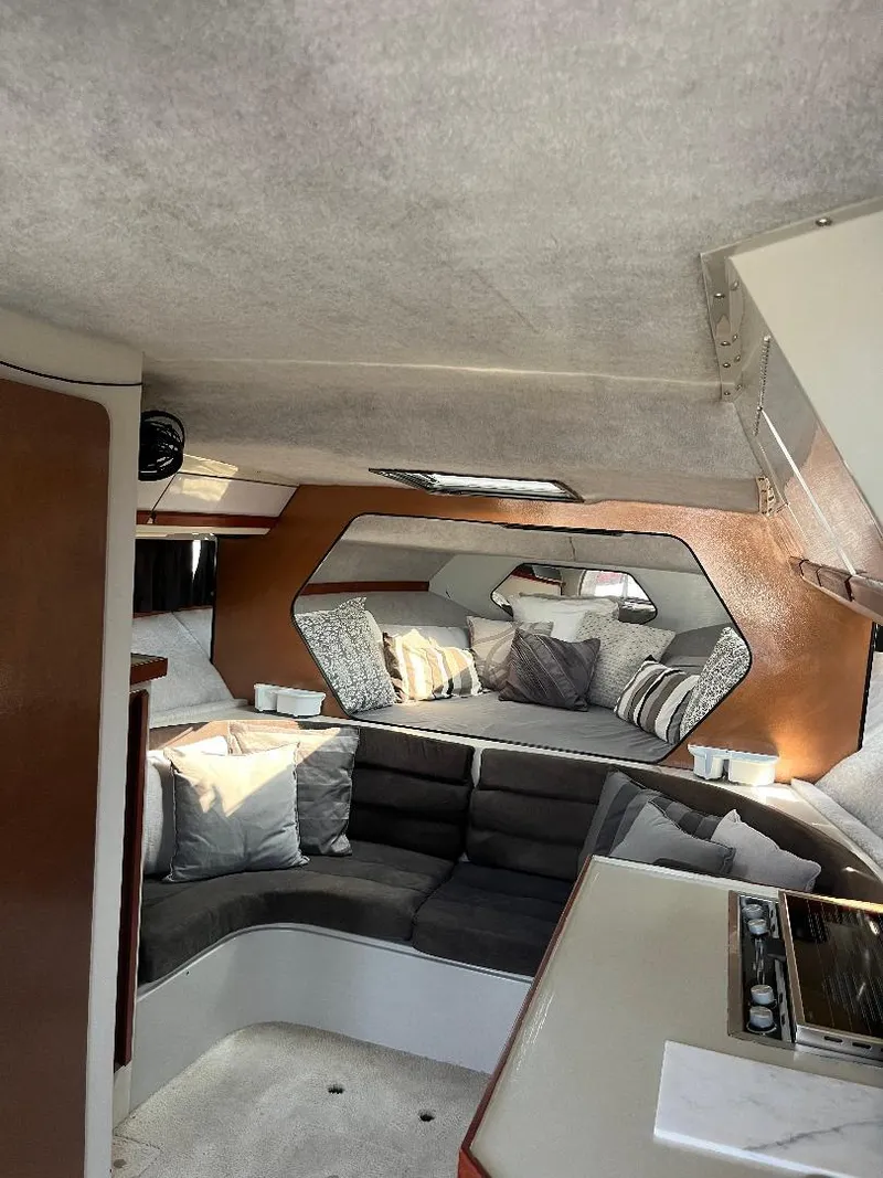 Slide: The Image of Interior of 1988 Carver 2767 Santego boat with cozy seating and modern design. - 13