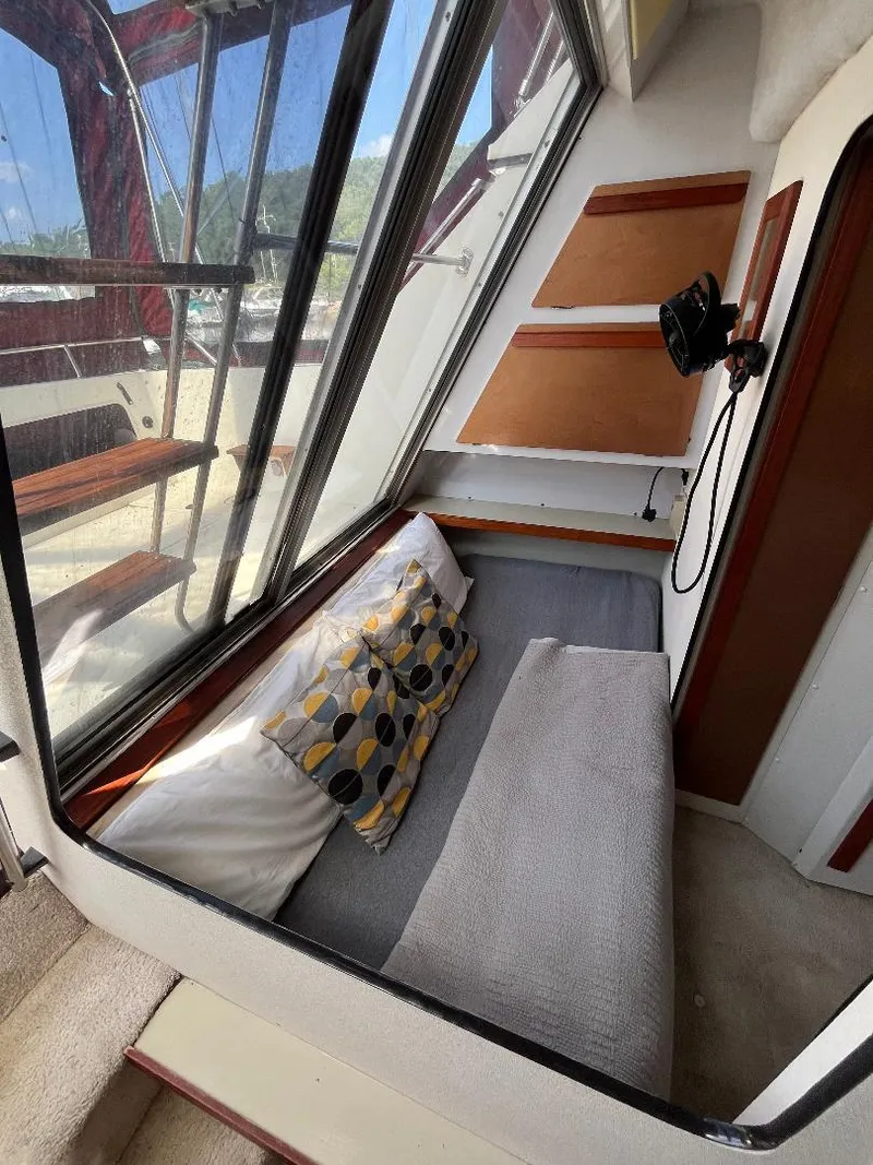 Slide: The Image of 1988 Carver 2767 Santego interior with cushioned seating and decorative pillows. - 14