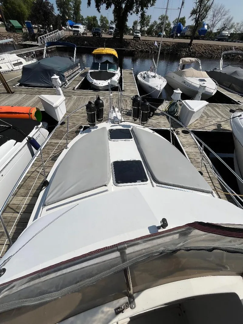 Slide: The Image of 1988 Carver 2767 Santego boat docked among other vessels at a marina. - 17