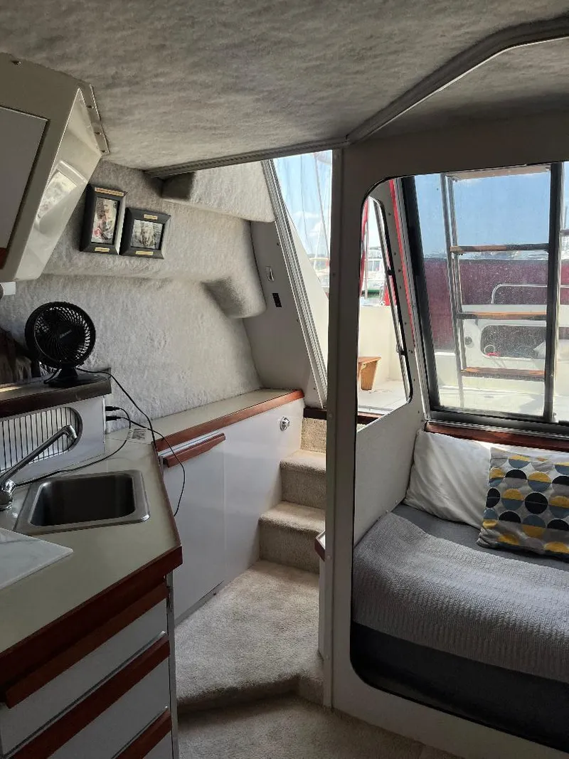 Slide: The Image of Interior of 1988 Carver 2767 Santego boat with cozy seating and kitchenette. - 19
