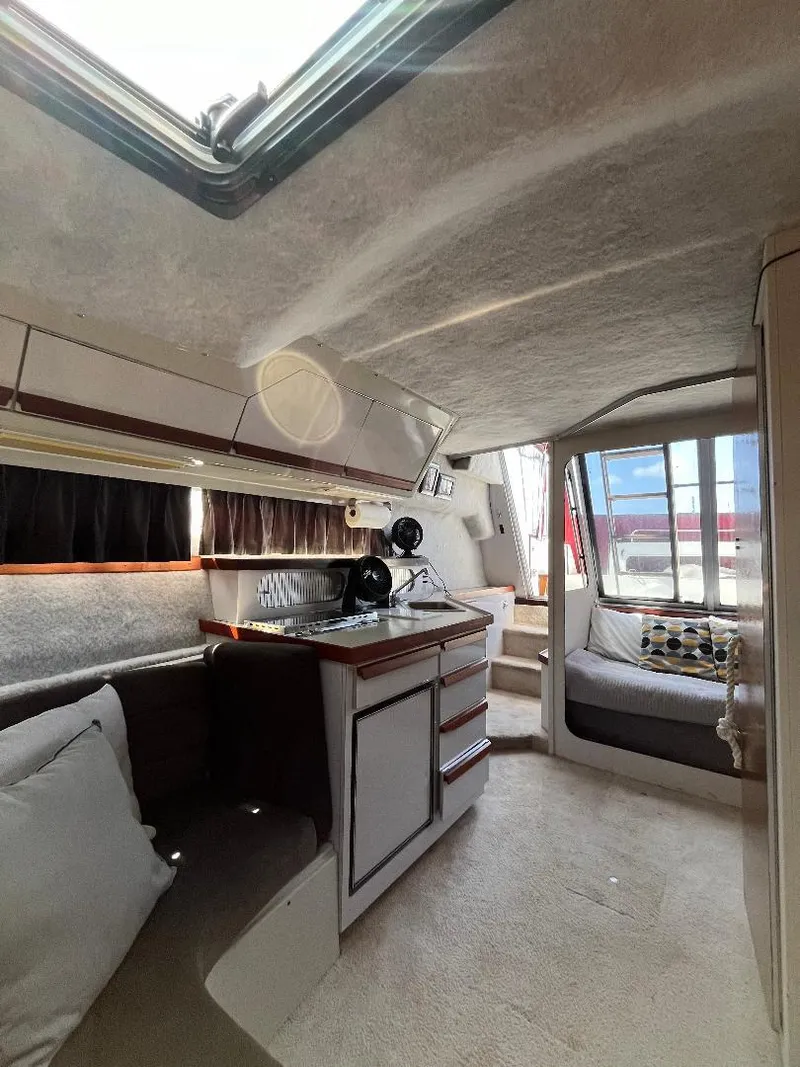 Slide: The Image of Interior of 1988 Carver 2767 Santego boat with cozy seating and kitchenette. - 22