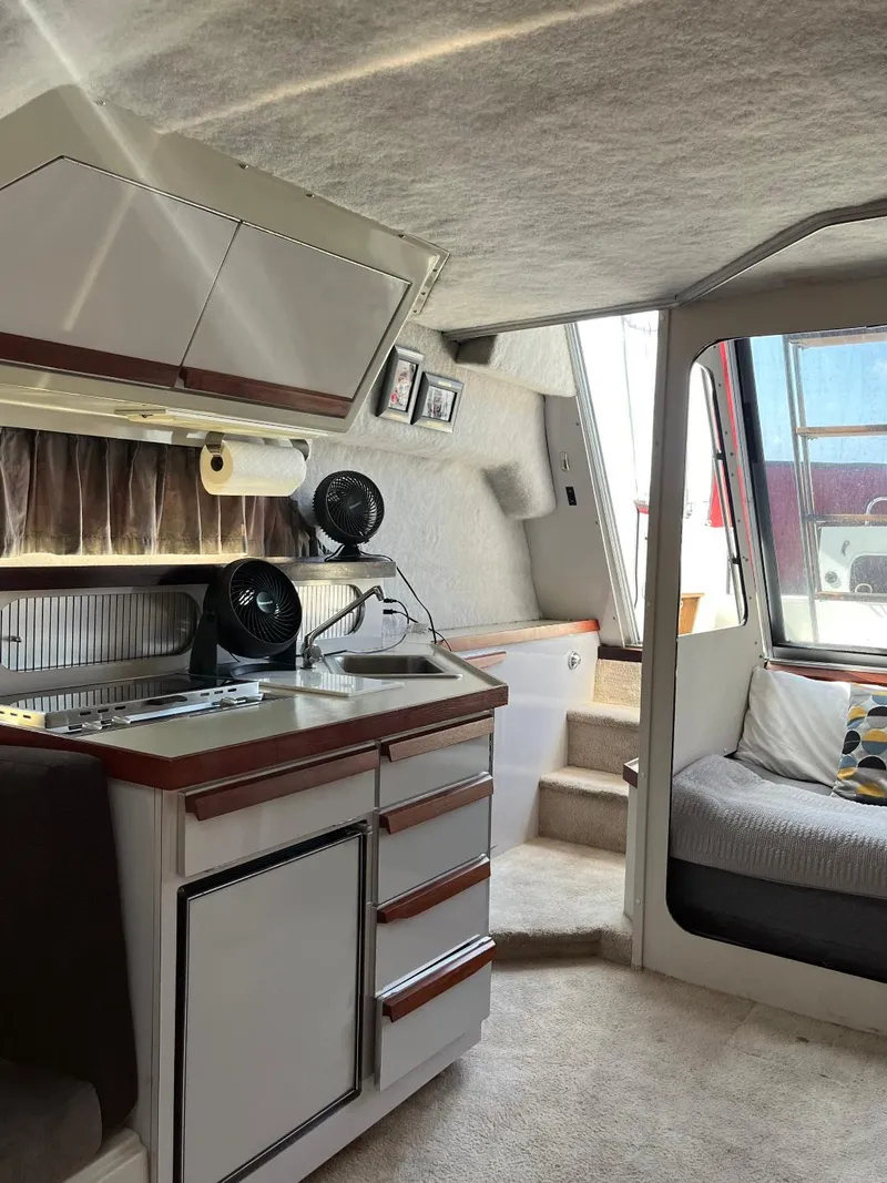 Slide: The Image of Interior of a 1988 Carver 2767 Santego boat with kitchenette and seating area. - 23