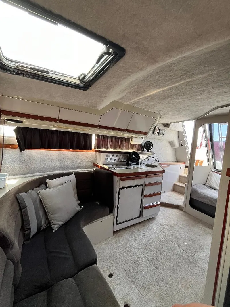 Slide: The Image of Interior of 1988 Carver 2767 Santego boat with seating, helm, and cabin features. - 24