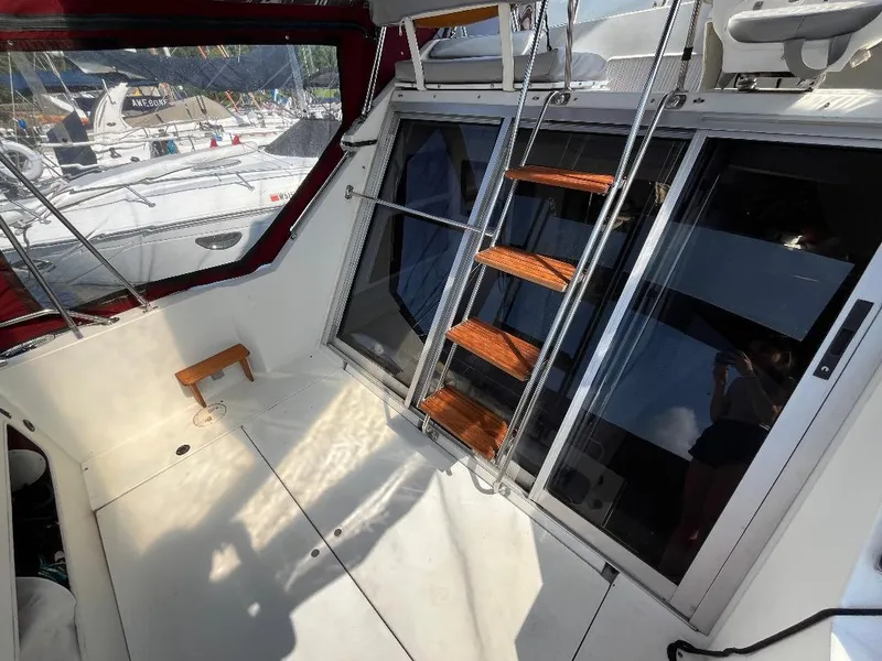 Slide: The Image of 1988 Carver 2767 Santego boat interior with wooden steps and large windows. - 25