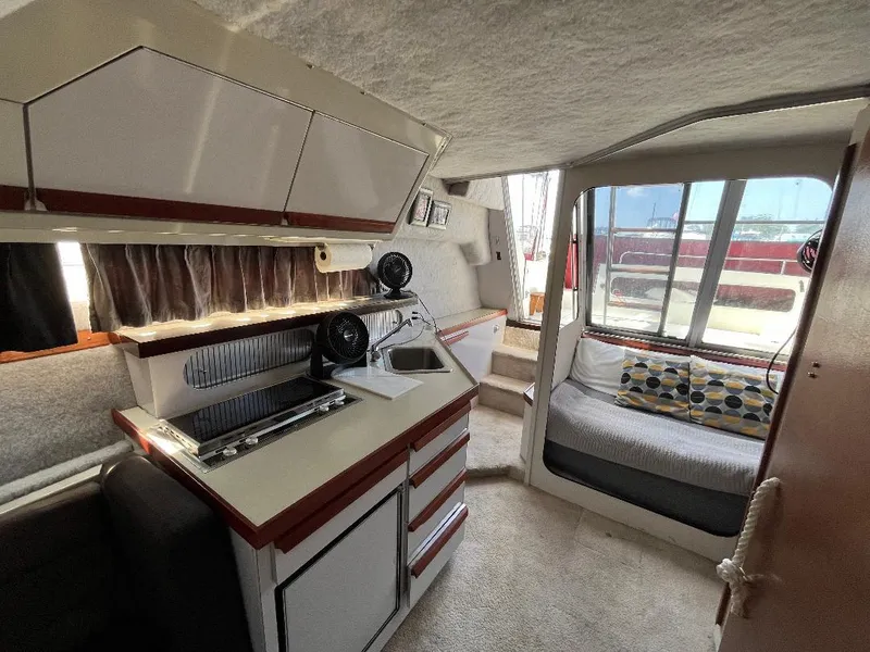 Slide: The Image of Interior of 1988 Carver 2767 Santego boat with kitchenette and seating area. - 27