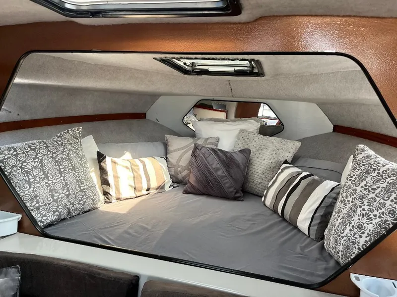 Slide: The Image of 1988 Carver 2767 Santego cabin interior with cozy bedding and decorative pillows. - 9