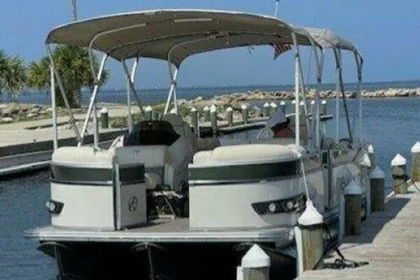 Slide: The Image of 2022 Avalon Catalina Platinum Quad Lounger 25' docked by the waterfront. - 2