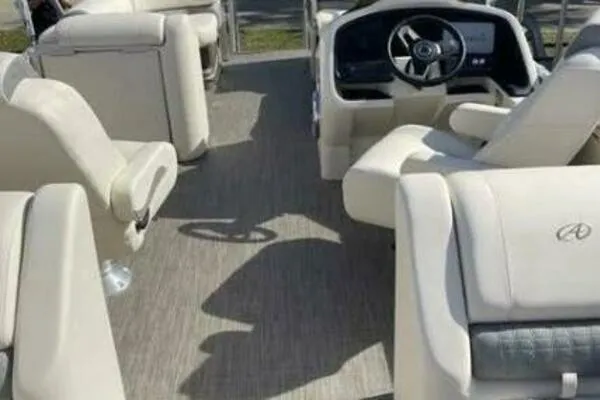Slide: The Image of Interior of 2022 Avalon Catalina Platinum Quad Lounger boat with plush seating and steering console. - 3