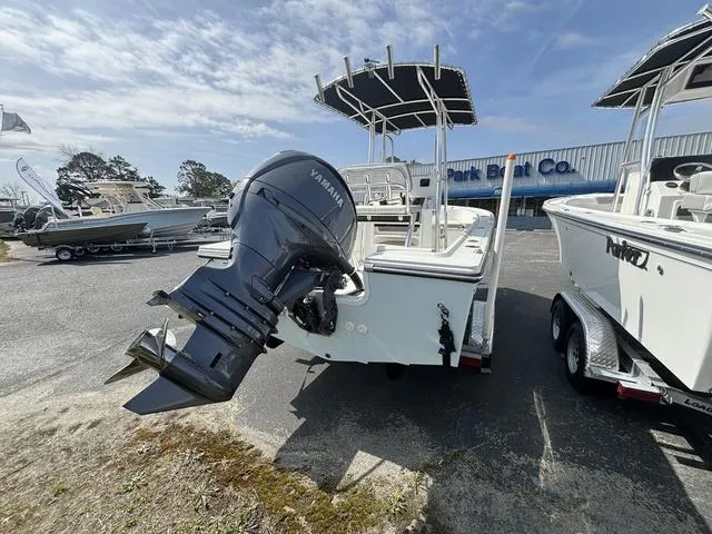 Slide: The Image of 2024 Parker 18 SE boat with Yamaha outboard motor at a dealership. - 7