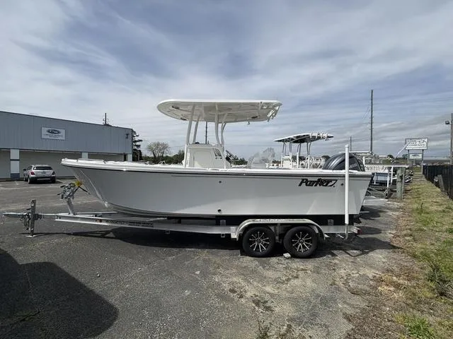 Slide: The Image of 2025 Parker 23 SE boat on trailer in parking lot, overcast sky. - 1