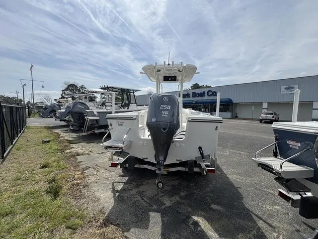 Slide: The Image of 2025 Parker 23 SE boat with 250 V6 engine at a dealership. - 2