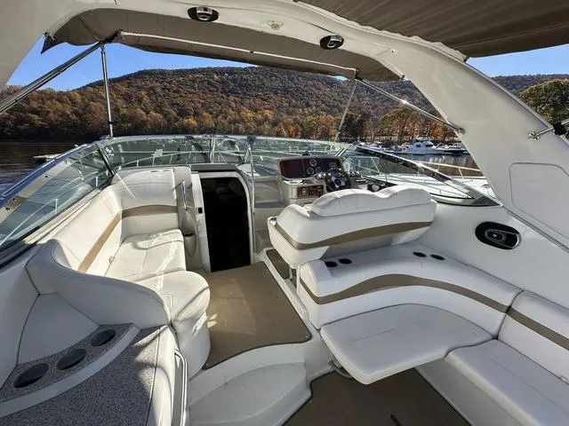 Slide: The Image of 2004 Formula 37PC yacht interior with white seating, scenic lake view, and autumn foliage. - 11