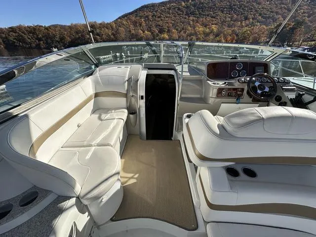 Slide: The Image of 2004 Formula 37PC yacht interior with white seating and scenic lake view. - 12
