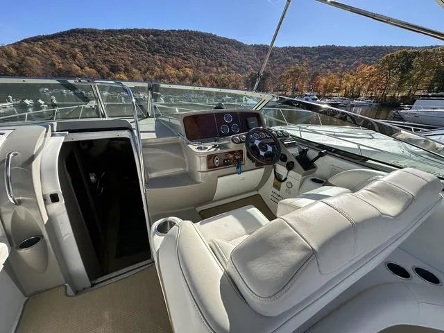 Slide: The Image of 2004 Formula 37PC yacht cockpit with luxurious seating and scenic mountain view. - 14