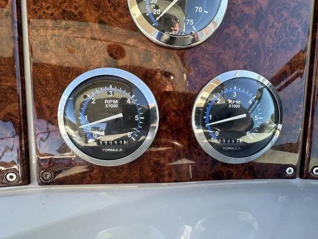 Slide: The Image of Dashboard of a 2004 Formula 37PC boat with RPM gauges. - 16