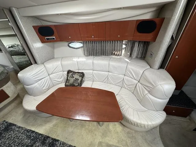 Slide: The Image of 2004 Formula 37PC yacht interior with white leather seating and wooden table. - 17