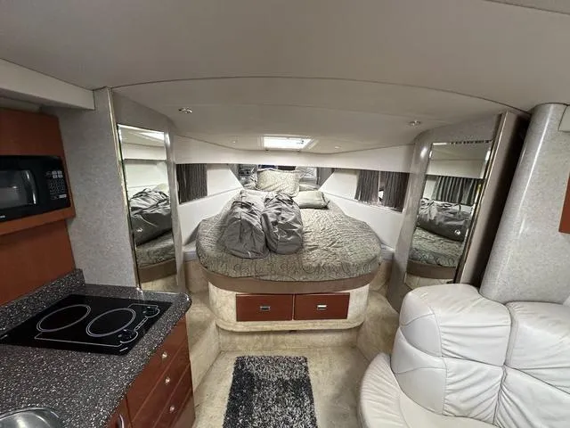 Slide: The Image of Interior of a 2004 Formula 37PC yacht with bed, kitchenette, and seating area. - 18