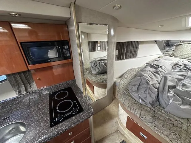 Slide: The Image of Interior of a 2004 Formula 37PC yacht with kitchen and cozy sleeping area. - 22