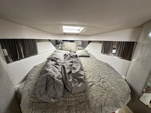 Slide: The Image of 2004 Formula 37PC cabin interior with bed, skylight, and curtains. - 24