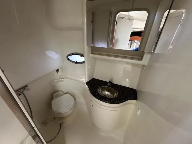 Slide: The Image of 2004 Formula 37PC yacht bathroom with sink, toilet, and porthole window. - 29