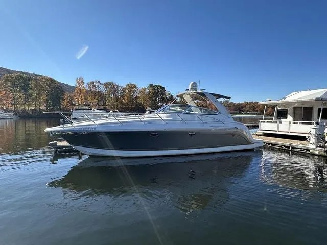 Slide: The Image of 2004 Formula 37PC yacht docked on a sunny day with autumn trees in the background. - 4