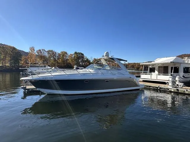 Slide: The Image of 2004 Formula 37PC yacht docked on a sunny day, surrounded by calm water and autumn trees. - 5