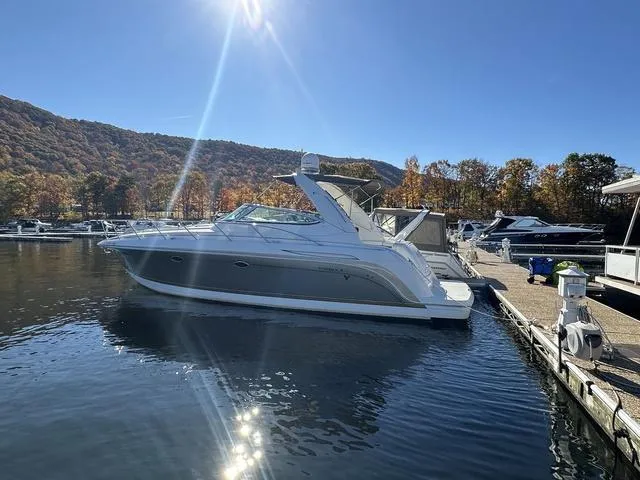 Slide: The Image of 2004 Formula 37PC yacht docked at a marina, surrounded by autumn foliage and calm water. - 6