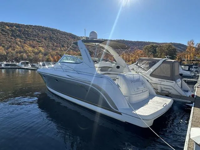 Slide: The Image of 2004 Formula 37PC boat docked on a sunny day with autumn foliage in the background. - 7