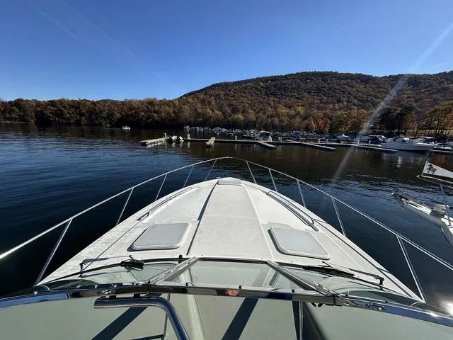 Slide: The Image of 2004 Formula 37PC boat on a serene lake with scenic mountain backdrop. - 9