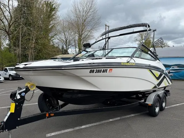 Slide: The Image of 2015 Yamaha Boats 212X on trailer, sleek design, parked outdoors. - 1