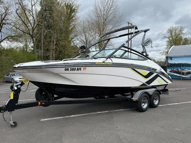 Slide: The Image of 2015 Yamaha Boats 212X speeding on water, featuring sleek design and wakeboard tower. - 2