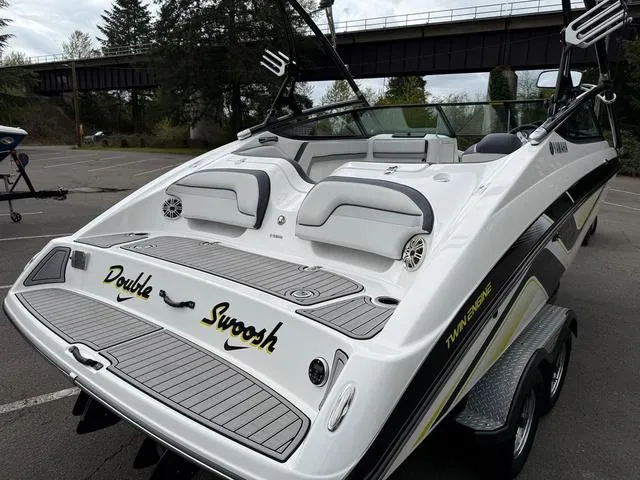 Slide: The Image of 2015 Yamaha Boats 212X on trailer, parked outdoors under clear sky. - 4