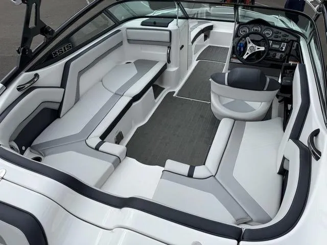 Slide: The Image of Interior view of 2015 Yamaha Boats 212X, showcasing steering wheel and dashboard controls. - 8