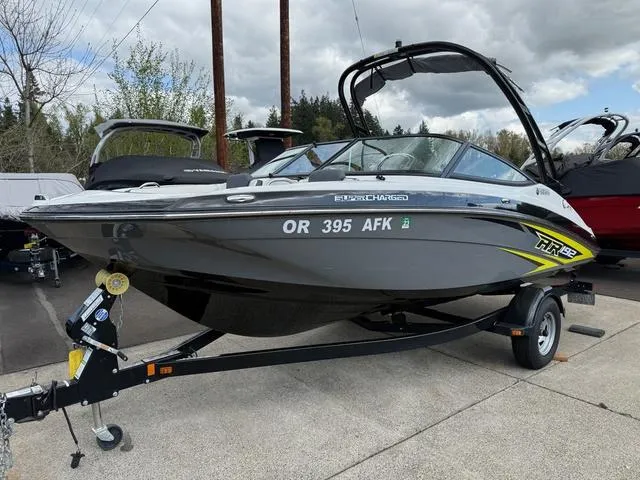 Slide: The Image of 2016 Yamaha AR192 boat on trailer, parked outdoors with trees and cloudy sky. - 1