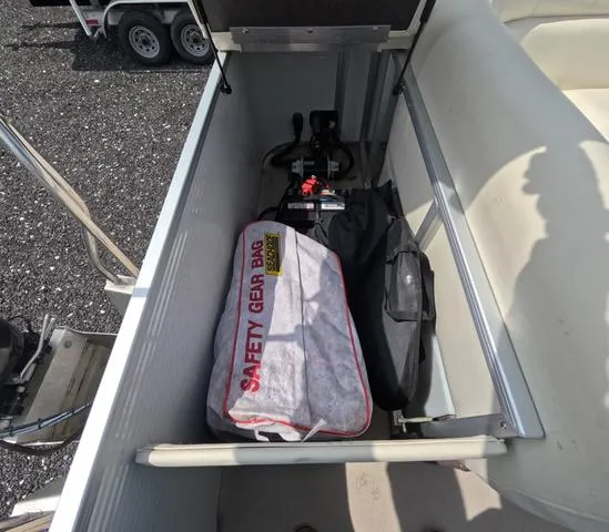 Slide: The Image of Storage compartment in a 2018 Sweetwater SW 2086 C boat with safety gear bag. - 17