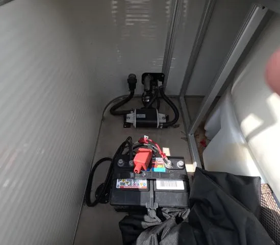 Slide: The Image of 2018 Sweetwater SW 2086 C boat battery and pump system in storage compartment. - 18