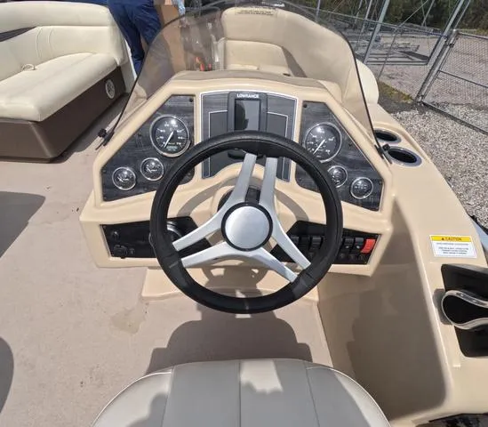 Slide: The Image of 2018 Sweetwater SW 2086 C boat dashboard with steering wheel and gauges. - 24