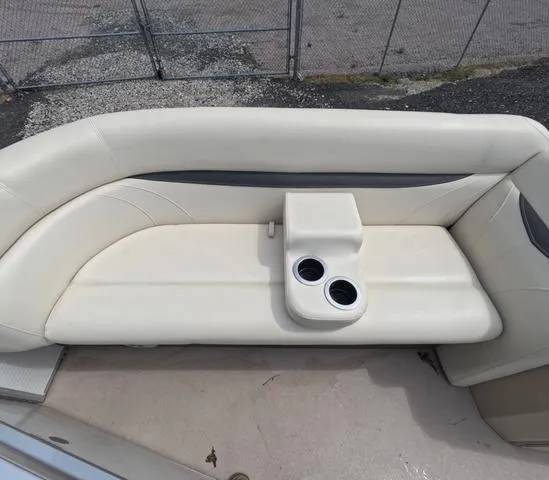 Slide: The Image of 2018 Sweetwater SW 2086 C boat interior with beige seating and cup holders. - 33
