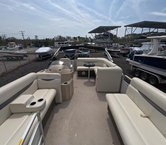 Slide: The Image of 2018 Sweetwater SW 2086 C pontoon boat with trailer, beige seating, parked in marina. - 35