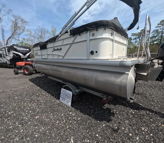 Slide: The Image of 2018 Sweetwater SW 2086 C pontoon boat with trailer, parked on gravel lot. - 4