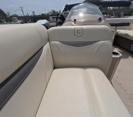 Slide: The Image of 2018 Sweetwater SW 2086 C boat interior with beige seating and console. - 42