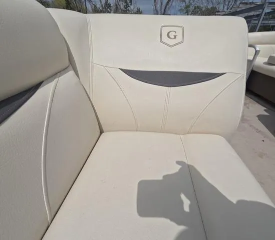 Slide: The Image of 2018 Sweetwater SW 2086 C boat interior with cream seating and logo. - 43